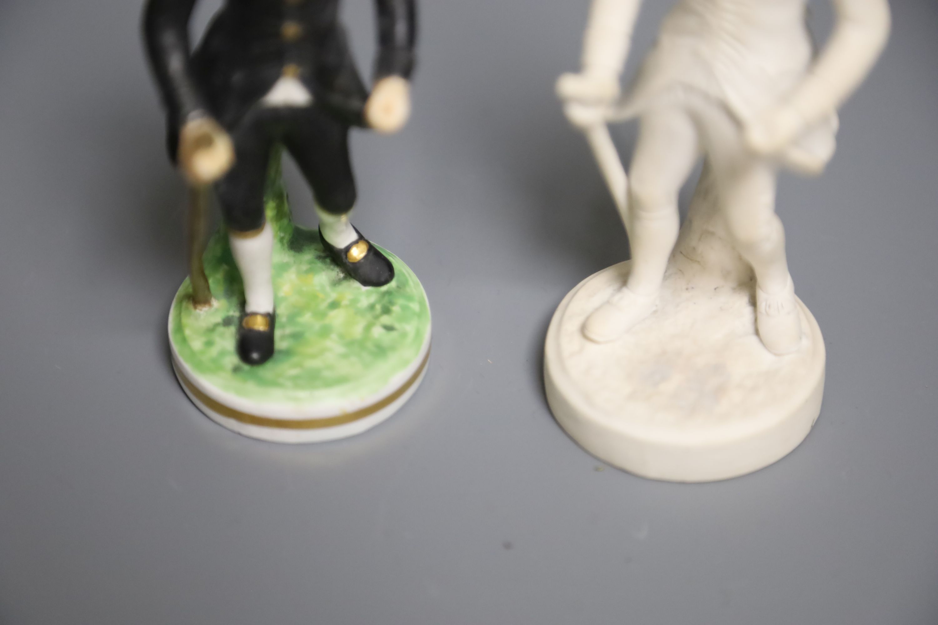 An early 19th century Derby rare biscuit figure of Dr. Syntax Walking and a later modelled Derby King Street of the same figure, 14cm